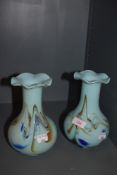 Two coloured glass vases with mottled blue and orange swirls