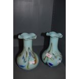 Two coloured glass vases with mottled blue and orange swirls