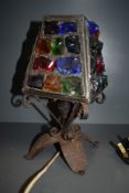 A charming vintage table lamb inset with large rustic pieces of colourful glass.