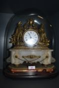 A 19th century domed mantle clock with ormelu decorated case, enamel face, dial and alabaster base