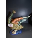 An early ceramic continental figure of a goose or swan possibly Majollica signed 23 to base (