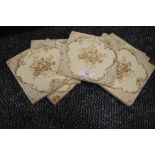 A set of seven early 20th century fireplace surround tiles having floral transfer pattern.