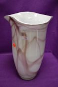 A large standing art glass vase having white ground under smoked pink with ground base