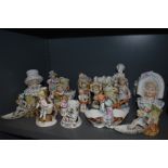 A selection of antique hard paste and bisque figurines including posy vase, garnitures and vesta,