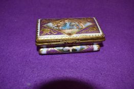 A hard paste continental trinket box hand decorated with mythical cherub and sea beast