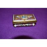 A hard paste continental trinket box hand decorated with mythical cherub and sea beast