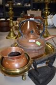 A mixed lot of brass and copper including kettles, jugs, flat iron, candlestick holders and more.