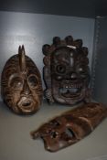 Three carved wooden masks.