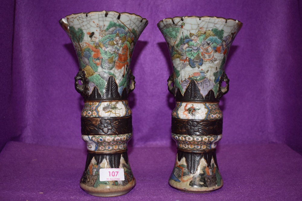 An impressive pair of Chinese export mantle vases in hard paste having extensive detailing of