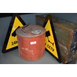 A military ammunition case, a petrol can and two Cctv signs
