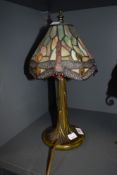 A stained glass Tiffany style desk lamp, having metal tree effect stand.