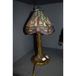 A stained glass Tiffany style desk lamp, having metal tree effect stand.