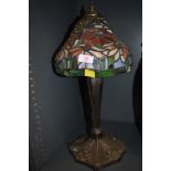 A Tiffany style table top lamp with cast base