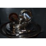 A collection of large metal platters,plates, bowls and similar.