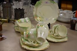 A vintage part Wellington china tea service having transfer and hand tinted decoration of water