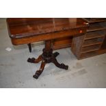 A William IV Rosewood fold over tea table, hollow section under top, on central turned column over