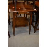 An early 20th Century late Arts and Crafts style oak occasional table, on square tapered legs,