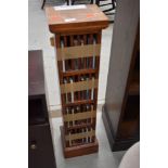 A modern hardwood CD rack and contents