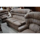 A vintage light brown leather three seater settee and two chairs