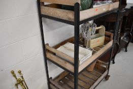 A large garden or similar 3 tier trolley and its contents, approx dimensions W81cm D48cm H130cm,