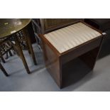 An early 20th Century piano or sewing stool with compartment below drop in seat