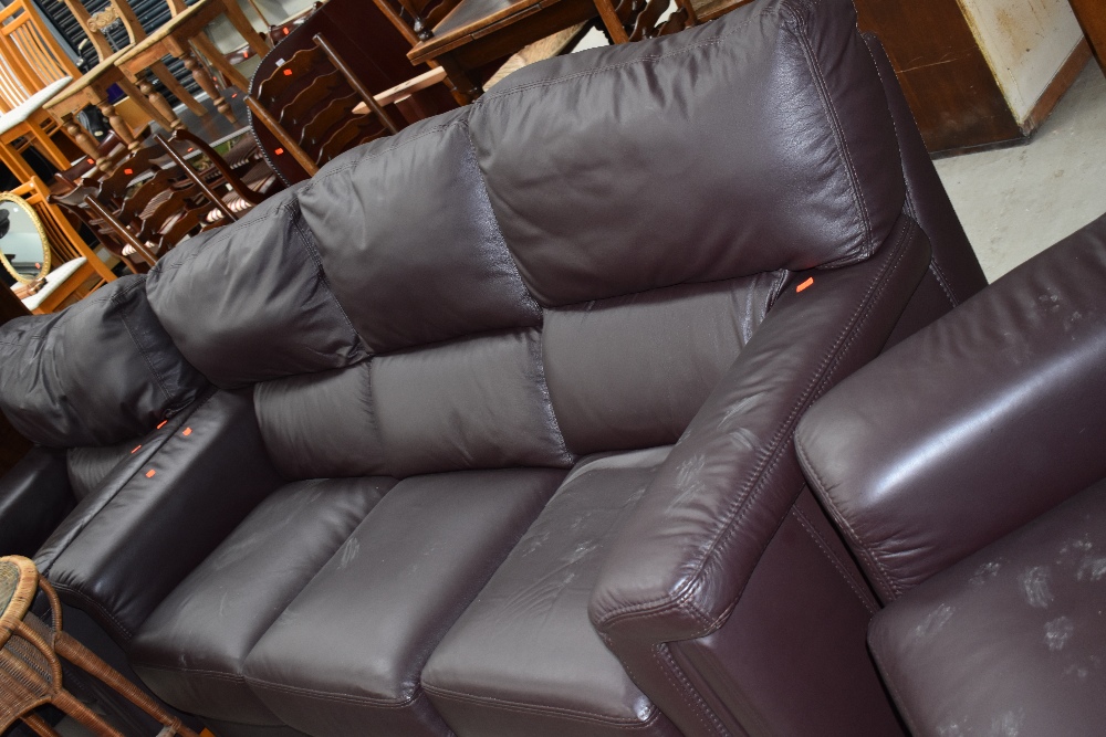 A modern dark brown leather three seater settee and two chairs