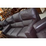 A modern dark brown leather three seater settee and two chairs