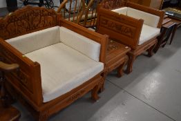 A pair of Thai hardwood throne style chairs, with matching occasional table, heavily carved elephant