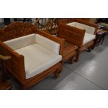 A pair of Thai hardwood throne style chairs, with matching occasional table, heavily carved elephant