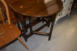 A nice quality traditional oak gate leg table, having bobbin turned legs, good proportions being
