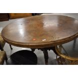 A Victorian walnut loo table, on four splay legs with pot casters, veneer lifting and flaking in