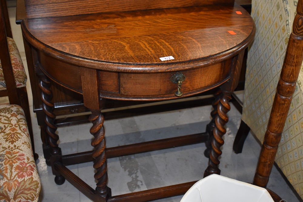 An early 20th Century demi lune hall table having frieze drawer on barley twist legs , width approx.