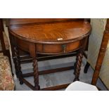 An early 20th Century demi lune hall table having frieze drawer on barley twist legs , width approx.