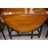 An early to mid 20th Century oak oval top gateleg dining table, approx width 90cm, open length