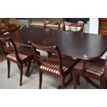 A reproduction Regency style mahogany extending dining table and set of six (four plus two)