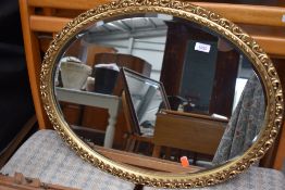 A gilt frame oval wall mirror, width approx. 67cm