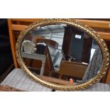 A gilt frame oval wall mirror, width approx. 67cm