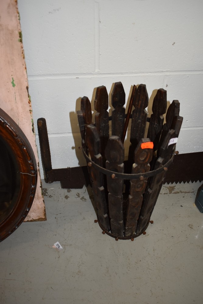 A rustic wooden umbrella stand