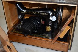 A vintage electric singer sewing machine, cased