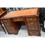 A late Victorian flame mahogany kneehole desk, having satinwood banding and inlay decoration in