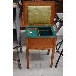 A vintage golden oak sewing table , having felt lined and part fitted interior, approx. width 47cm