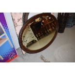 An early 20th Century oval mirror, approx, diameter 92cm