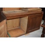 An early 20th Century golden oak bookcase, having double cupboard under, with interesting additional