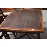 An early 20th Century oak drawer leaf table, square closed form on X frame, approx. width 91cm