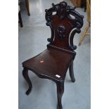 A 19th Century mahogany hall chair having shield back