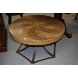 A modern exotic wood coffee table having swirl mosaic pattern top on metal base approx. diameter