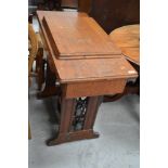 A vintage treadle sewing machine, in oak case, Singer