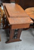 A vintage treadle sewing machine, in oak case, Singer