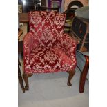 An early 20th Century tub armchair on cabriole legs and ball and claw feet, width approx. 63cm