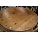 A traditional pine circular dining table, on carved triple splay legs , diameter approx. 120cm